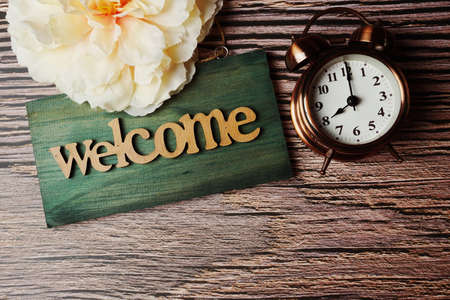 Wooden Closed sign and alarm clock with space copy on wooden backgroundの写真素材