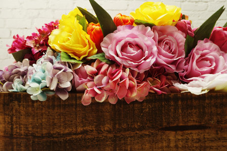 Artificial flower wit space copy on wooden background