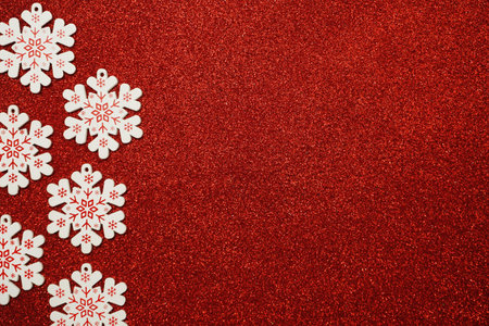 wooden snowflake border frame on red glitter background