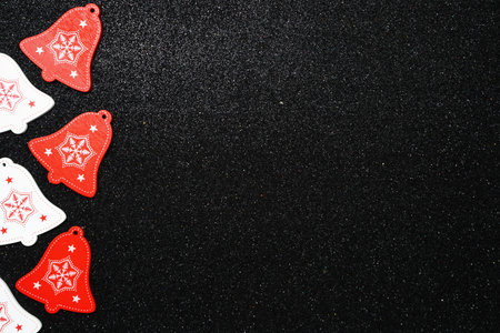 Red and white Bell Christmas Decoration with space copy on black glitter background