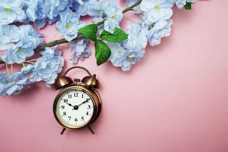 Vintage Alarm Clock And Tulip Bouquet with space copy on pink backgroundの写真素材