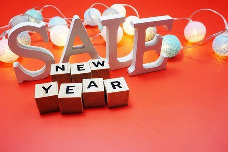 New Year Sale with led cotton balls decoration on red backgroundの写真素材