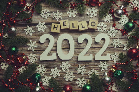 Hello 2022 alphabet letters with Christmas decoration on wooden backgroundの写真素材