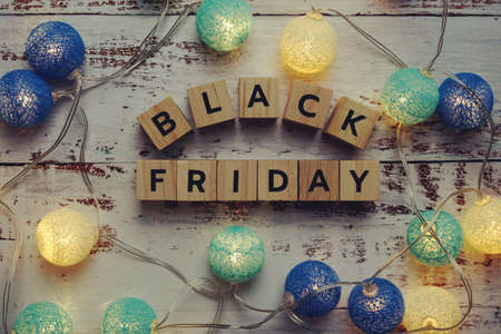 Black Friday alphabet letter and LED cotton balls on wooden backgroundの写真素材