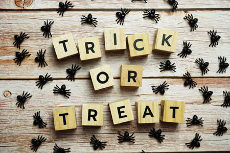 Halloween concept flat lay Trick or Treat alphabet letters on wooden backgroundの写真素材