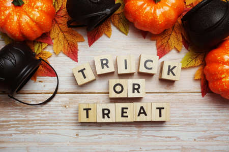 Trick or Treat alphabet letter with Halloween decoration on wooden backgroundの写真素材