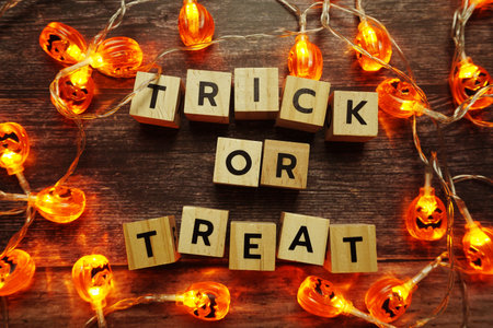 Halloween concept flat lay Trick or Treat alphabet letters on wooden background
