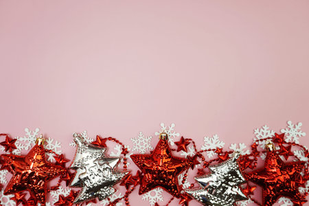 Flat lay composition with Christmas decorations accessories on pink background
