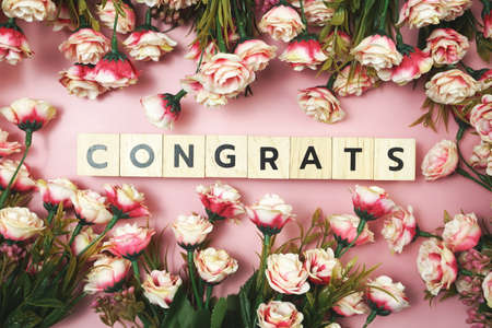 Congrats alphabet letter with Blooming flower on pink backgroundの写真素材