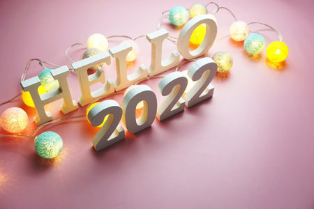 Hello 2022 alphabet letter with cotton ball LED decoration on pink backgroundの写真素材