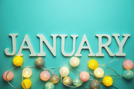 January alphabet letter with cotton ball LED decoration on blue backgroundの写真素材