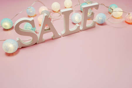 Sale alphabet letter with cotton balls decoration on pink backgroundの写真素材