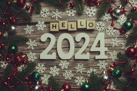 Hello 2024 alphabet letters with Christmas decoration on wooden backgroundの写真素材