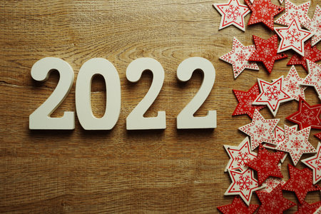2022 Happy new year with white and red star ornament decoration on wooden background
