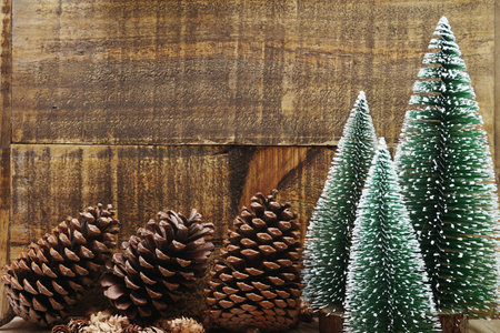 Christmas Festive background concept decoration with Christmas tree and pine cones on wooden...