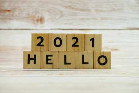 Hello 2021 alphabet letter on wooden background