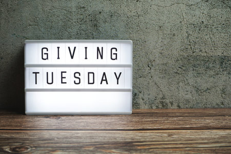 Giving Tuesday word in light box on wooden backgroundの写真素材