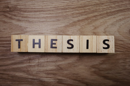 Thesis word alphabet letters on wooden background