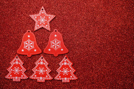 Red Star Bell and Christmas Tree Decoration with space copy on red glitter backgroundの写真素材