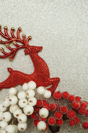 Red Reindeer and white berry Christmas decoration on red glitter backgroundの写真素材