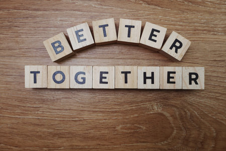 Better Together alphabet letter on wooden background