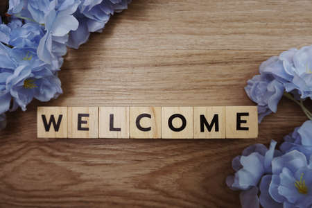 Welcome alphabet letter with space copy on wooden backgroundの写真素材