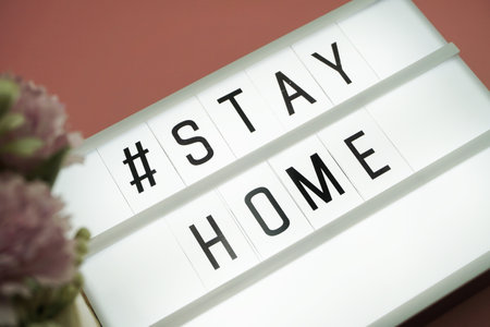 Stay Home word in light box on pink backgroundの写真素材