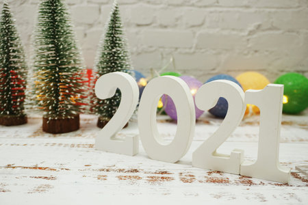 Happy New Year 2021 festive background with christmas tree on white brick wall background