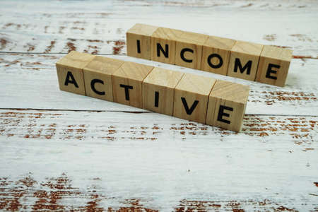Active Income Word alphabet letters on wooden backgroundの写真素材