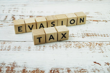 Tax Evasion Word alphabet letters on wooden backgroundの写真素材