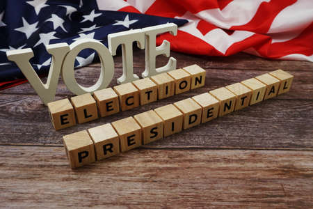 Vote Election Presidential Word alphabet letters with USA flag on wooden backgroundの写真素材