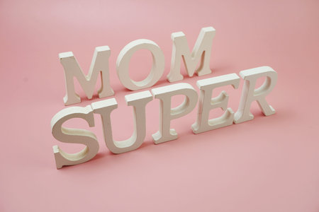 Super Mom word alphabet letters on pink background
