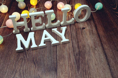 Hello May alphabet letters with LED cotton balls decoration on wooden backgroundの写真素材