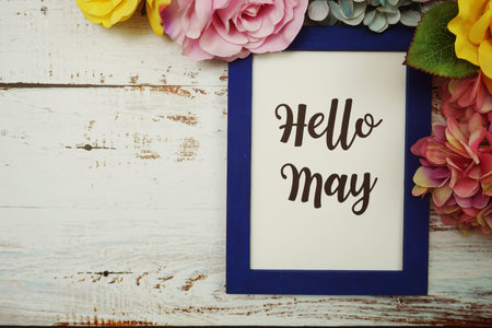 Hello May Card with colorful flowers border frame on wooden background