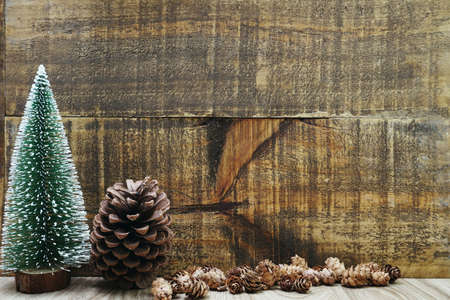 Christmas Festive background concept decoration with Christmas tree and pine cones on wooden backgroundの写真素材