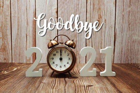 Goodbye 2021 calligraphy alphabet letter and Christmas tree Holiday Decoration on wooden backgroundの写真素材