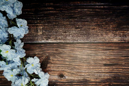 Top view Blooming Flowers frame with copy space on wooden backgroundの写真素材