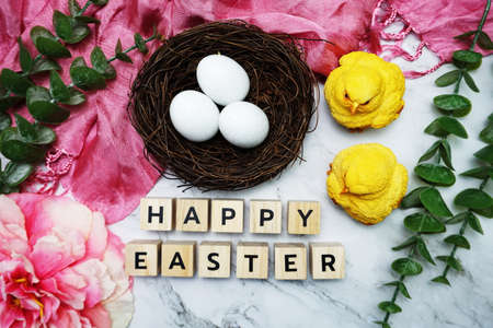 Happy Easter alphabet letter with bird nest and flower decoration on marble backgroundの写真素材