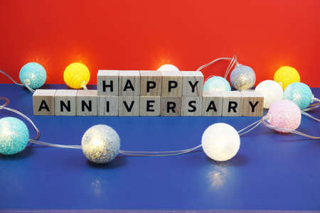 Happy Anniversary alphabet letter with LED cotton balls on blue backgroundの写真素材