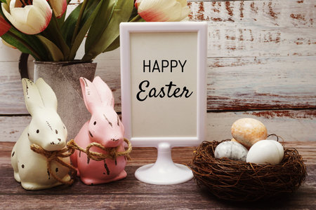 Happy Easter with flower, rabbit and easter eggs decoration on wooden backgroundの写真素材