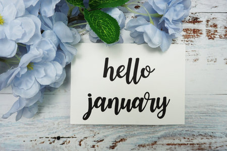 Hello January Card with Blooming flower on wooden background