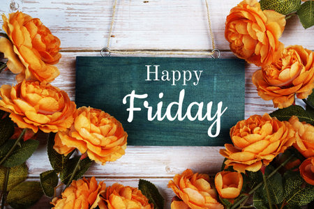 Happy Friday typography text with flower decoration on wooden background