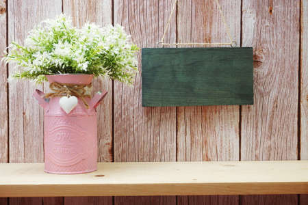 Empty wooden board hanging on wooden backgroundの写真素材