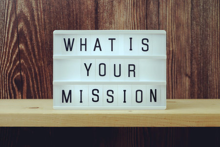 What is your Mission word in light box on wooden background