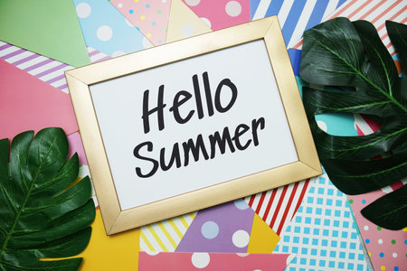 Hello Summer text with green leave decoration on colorful backgroundの写真素材