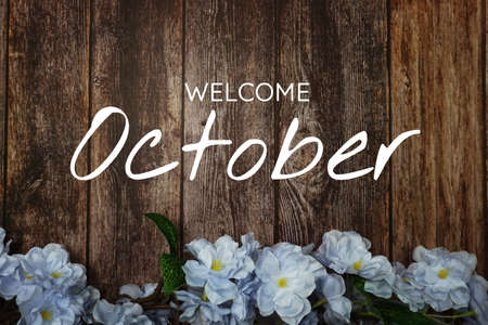 Welcome October text and blue flower decoration onの写真素材