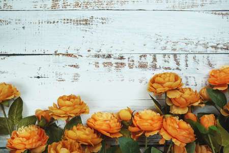 Top view Blooming Flowers frame with copy space on wooden backgroundの写真素材