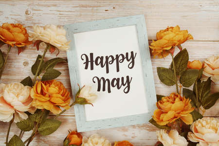 Happy May typography text with flower decoation on wooden backgroundの写真素材