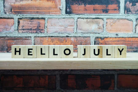Hello July alphabet letter on shelves wooden backgroundの写真素材