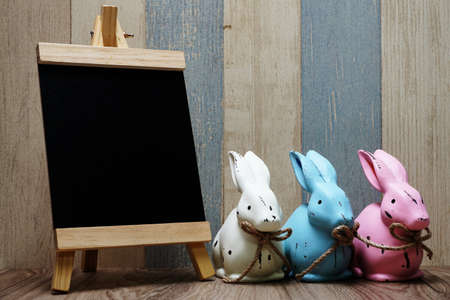 happy easter with bunny rabbit and space copy wooden easel backgroundの写真素材